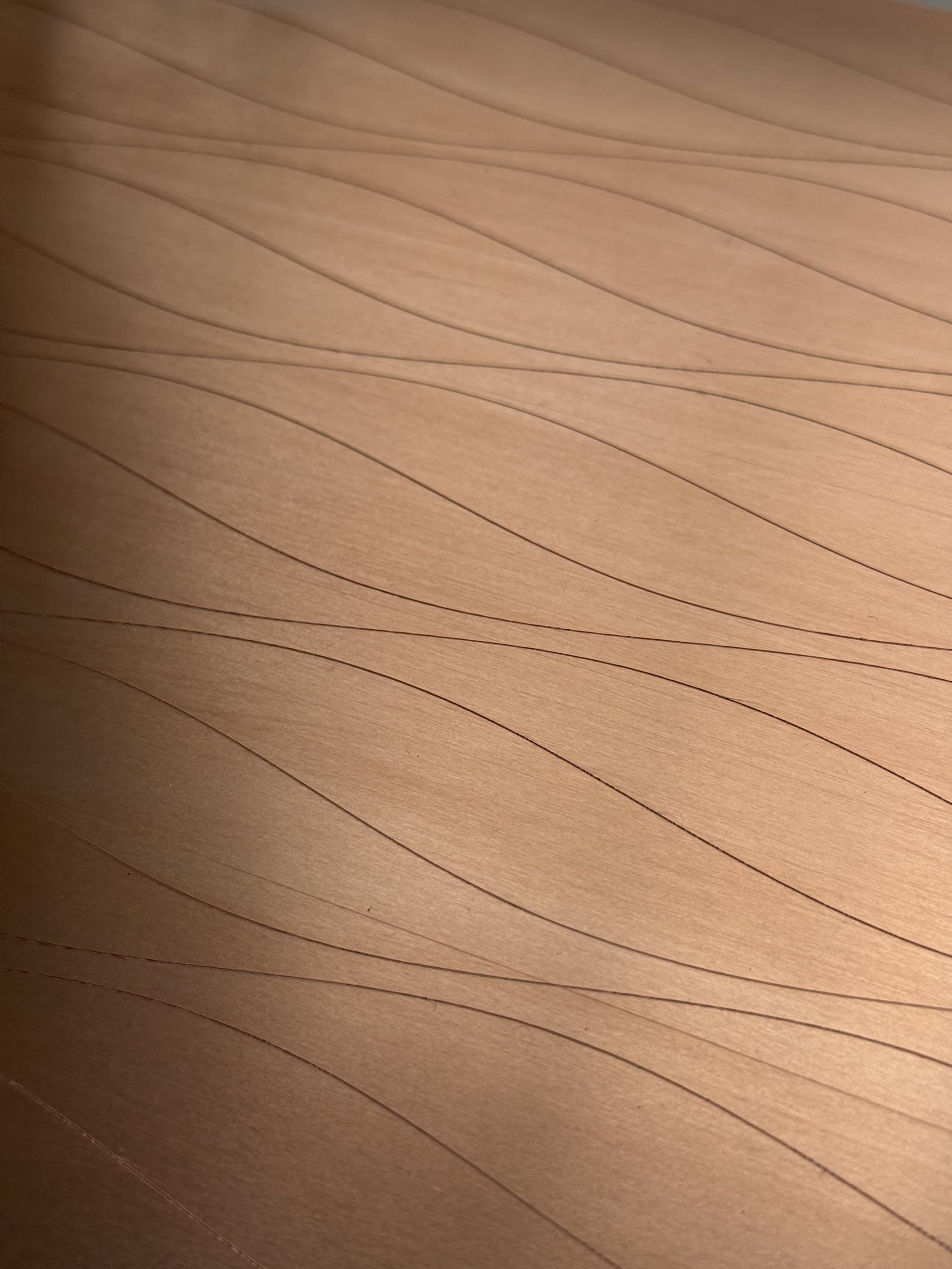 Partition. A pen plotter draws fine wavy lines across a copper plate. Pascal Piron, 2026